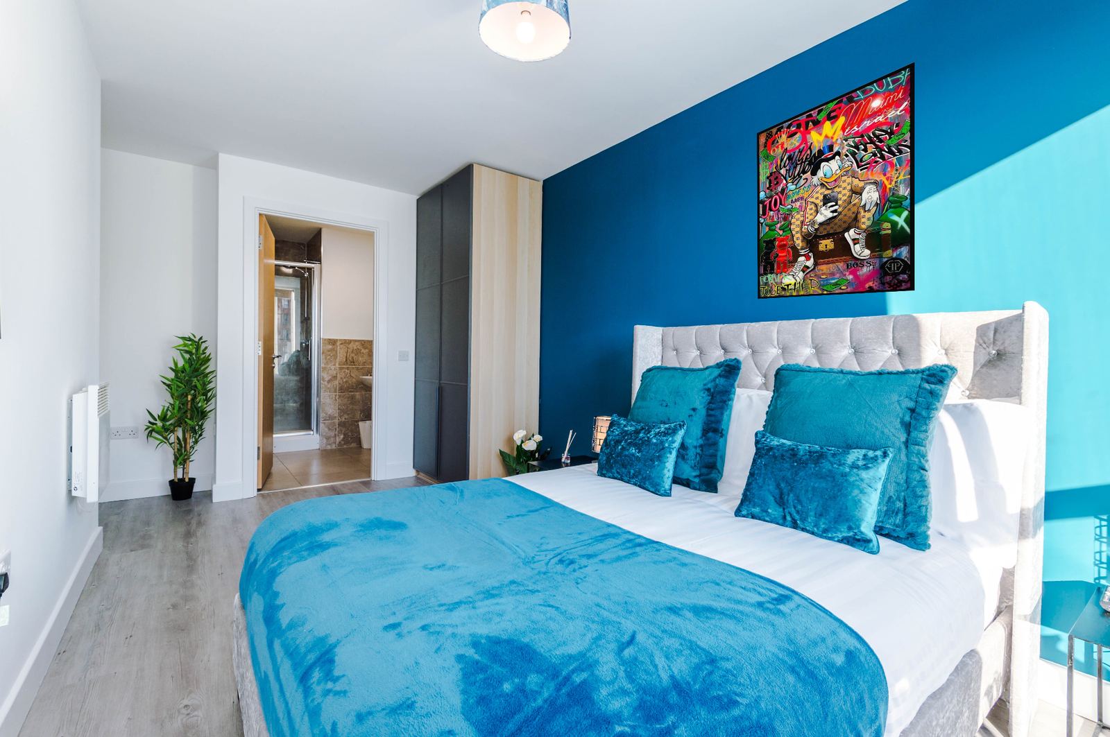 Bridgewater main bedroom with bold blue feature wall and ensuite