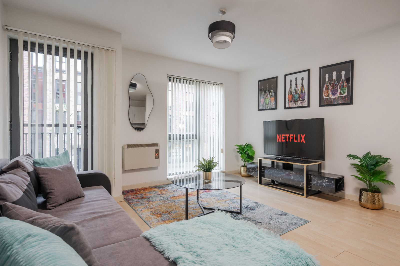 Staged living room with grey sofa, statement art and styled coffee table