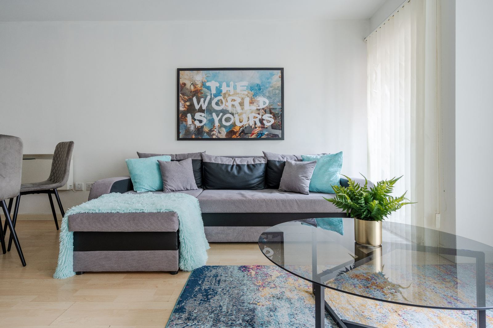 Staged lounge with feature artwork, cushions and soft furnishings